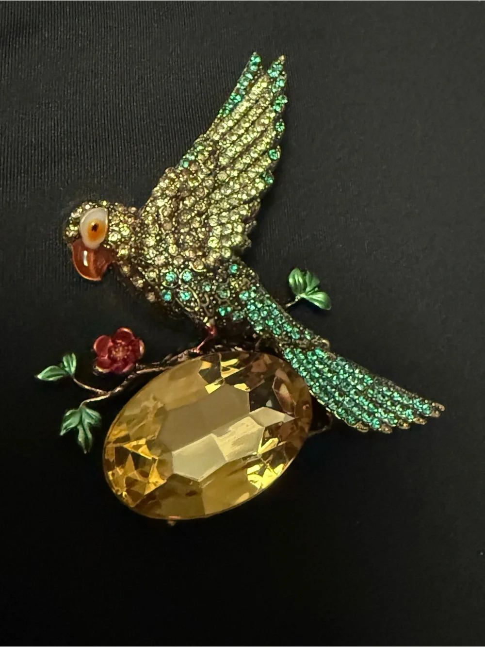 vintage-inspired green crystal parrot brooch with yellow stone
